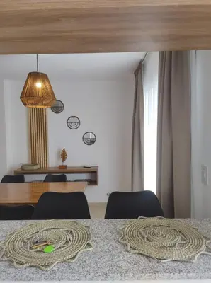 a room with a table with chairs and a lamp at Hermoso Departamento confort y calidad in Cordoba