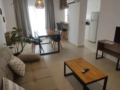 a living room with a couch and a table at Hermoso Departamento confort y calidad in Cordoba