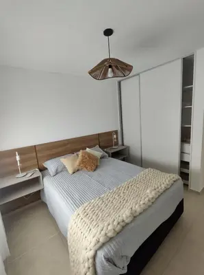 a bedroom with a bed with a cat laying on it at Hermoso Departamento confort y calidad in Cordoba