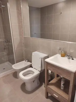 a bathroom with a toilet and a sink and a shower at Hermoso Departamento confort y calidad in Cordoba