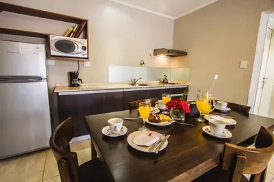 a kitchen with a wooden table with food on it at BlackStone Apart Boutique Hotel in Villa General Belgrano