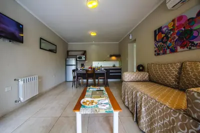 a living room with a couch and a table at BlackStone Apart Boutique Hotel in Villa General Belgrano