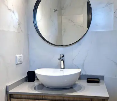 a bathroom with a large white sink and a mirror at BlackStone Apart Boutique Hotel in Villa General Belgrano