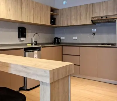 a kitchen with wooden cabinets and a counter top at BlackStone Apart Boutique Hotel in Villa General Belgrano