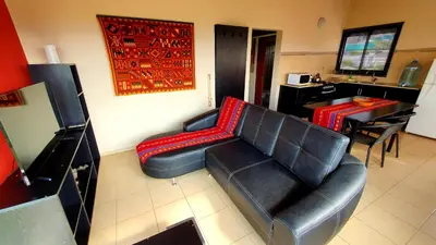 a living room with a leather couch and a table at Alta Morada in Villa Carlos Paz