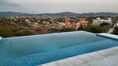 a swimming pool with a view of a city at Alta Morada in Villa Carlos Paz