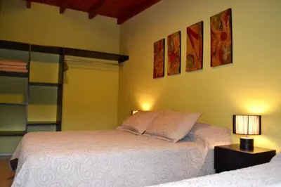 a bedroom with a white bed with two pillows at Alta Morada in Villa Carlos Paz