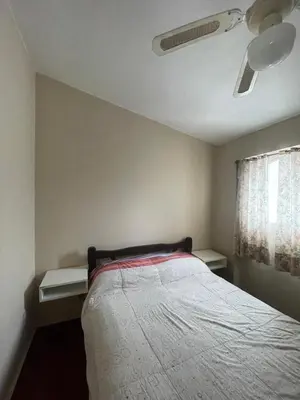 a bedroom with a bed and a ceiling fan at Comodo departamnto con asador in Villa Carlos Paz