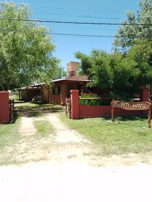 a building with a sign that reads just happy at INTI MAYU Cabañas in Mina Clavero