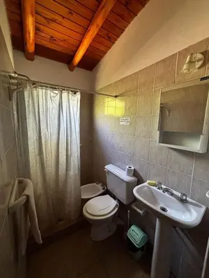 a bathroom with a toilet and a sink at INTI MAYU Cabañas in Mina Clavero