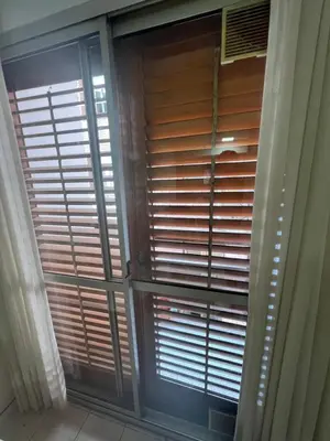 a window with wooden blinds in a room at Alojamiento Buen Pastor in Cordoba