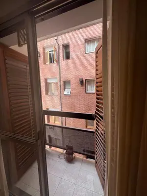 a view of a building from a room with a window at Alojamiento Buen Pastor in Cordoba