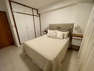 a bedroom with a bed with white sheets and pillows at Alojamiento Buen Pastor in Cordoba