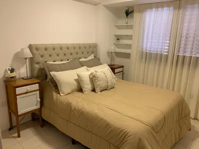a bedroom with a large bed with pillows and a window at Alojamiento Buen Pastor in Cordoba