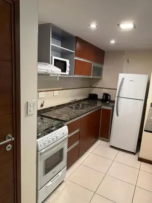 a kitchen with a stove and a white refrigerator at San Lorenzo 490 - Nueva Córdoba in Cordoba