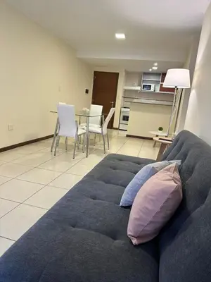 a living room with a blue couch and a table at San Lorenzo 490 - Nueva Córdoba in Cordoba