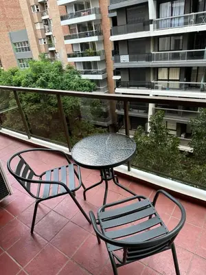 a patio with a table and chairs on a balcony at San Lorenzo 490 - Nueva Córdoba in Cordoba