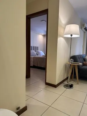 a living room with a couch and a floor lamp at San Lorenzo 490 - Nueva Córdoba in Cordoba