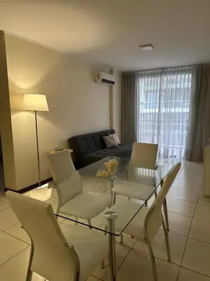 a living room with a glass table and chairs at San Lorenzo 490 - Nueva Córdoba in Cordoba