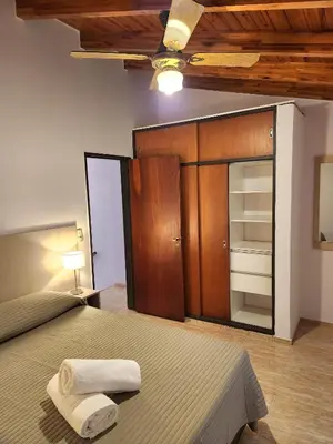 a bedroom with a bed with two towels on it at Vacaciones Diferentes 25 de Mayo in Villa Carlos Paz