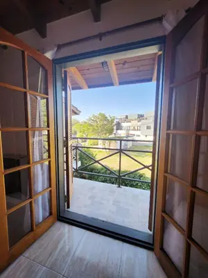 an open door with a view of a balcony at Vacaciones Diferentes 25 de Mayo in Villa Carlos Paz