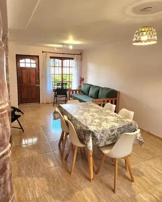 a dining room with a table and chairs at Vacaciones Diferentes 25 de Mayo in Villa Carlos Paz