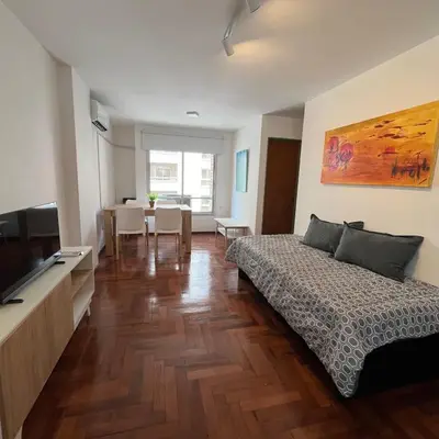 a room with a bed and a television and a table at San Lorenzo 495 bis, Nueva Córdoba in Cordoba