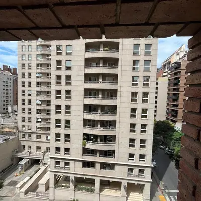 a tall white building with balconies in a city at San Lorenzo 495 bis, Nueva Córdoba in Cordoba