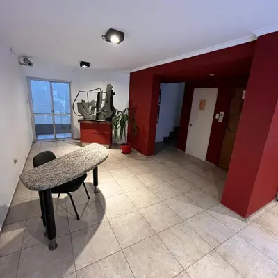 a room with a table and a room with red walls at San Lorenzo 495 bis, Nueva Córdoba in Cordoba