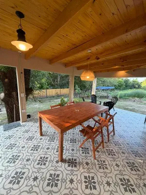a wooden table and chairs on a patio at Casa Playa Mansa in Mina Clavero