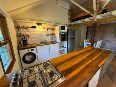 a kitchen with a wooden counter top in a room at Casa Playa Mansa in Mina Clavero