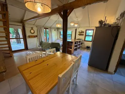 a dining room with a wooden table and chairs at Casa Playa Mansa in Mina Clavero