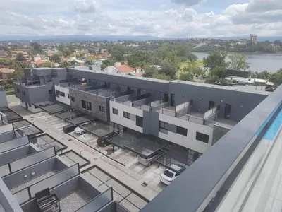 an overhead view of a building with a parking lot at Dpto en Carlos Paz con vista al Lago in Villa Carlos Paz