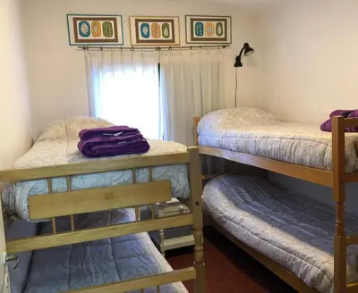 two bunk beds in a room with a window at Casa de Beto Estancia Vieja in Estancia Vieja