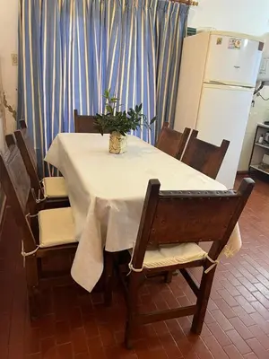 a table with a white table cloth and a plant on it at Casa de Beto Estancia Vieja in Estancia Vieja