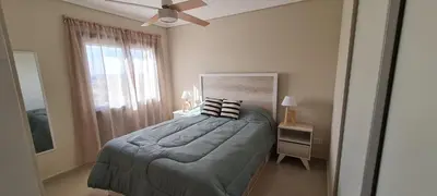 a bedroom with a bed with a ceiling fan and a window at Vista al Kempes in Cordoba