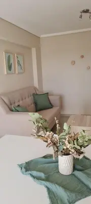a living room with a couch and a potted plant at Vista al Kempes in Cordoba