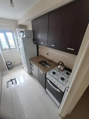 a small kitchen with a stove and a refrigerator at Vista al Kempes in Cordoba