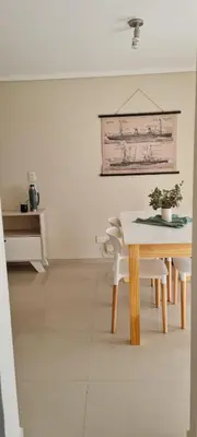 a dining room with a table and a table and chairs at Vista al Kempes in Cordoba