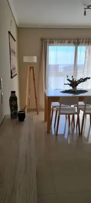 a dining room with a table and chairs and a window at Vista al Kempes in Cordoba