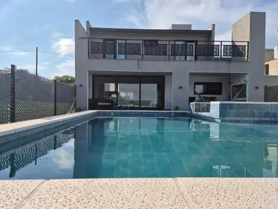 a swimming pool in front of a house at La Palmerita !! in Cordoba