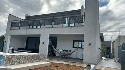 a house with a balcony on top of it at La Palmerita !! in Cordoba