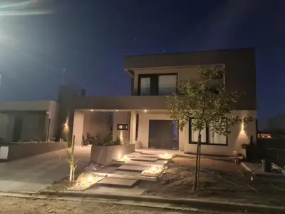a house with lights in front of it at night at La Palmerita !! in Cordoba
