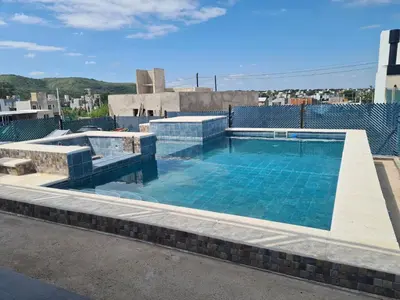 a swimming pool on the roof of a building at La Palmerita !! in Cordoba