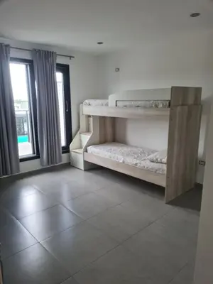 a room with two bunk beds and a window at La Palmerita !! in Cordoba