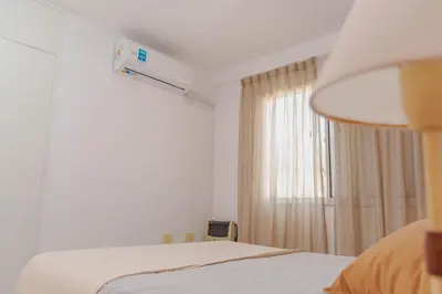 a white room with a bed and a window at Depto 4 in Villa Carlos Paz