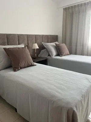 a bedroom with two beds and a window at Depto 3 in Villa Carlos Paz