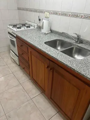 a kitchen with a sink and a stove at Depto 3 in Villa Carlos Paz