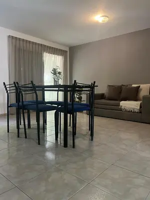 a dining room with a table and chairs and a couch at Depto 3 in Villa Carlos Paz
