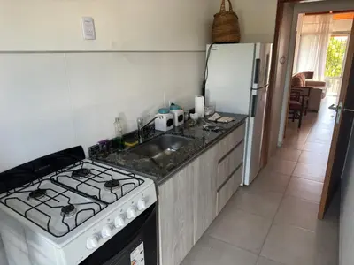 a kitchen with a stove and a sink and a refrigerator at Hermoso departamento en alquiler in Cordoba